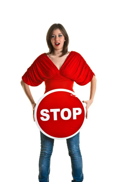Beautiful young woman holding a stop sign — Stock Photo, Image