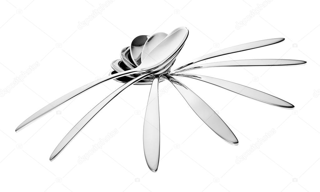 Silver spoons in abstract composition