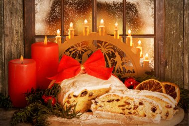 Christmas Stollen, Dresden Stollen with Candle Arch before wintry window clipart