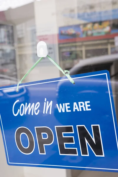 Open sign on a window door Stock Picture