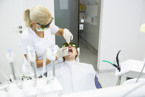 Dentist using a modern diode dental laser