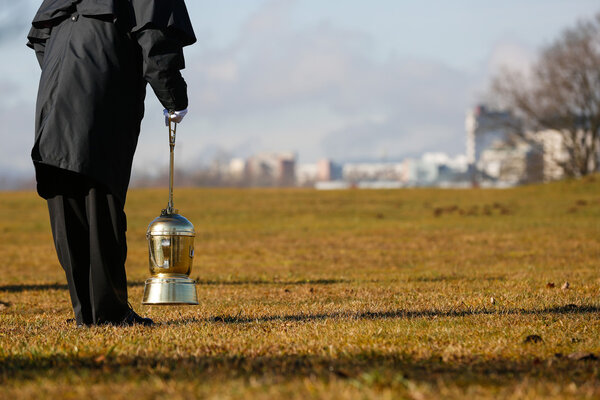 Undertaker scattering ashes of a cremated human 