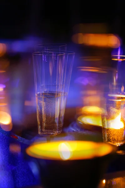 Blurred candlelit champagne glasses