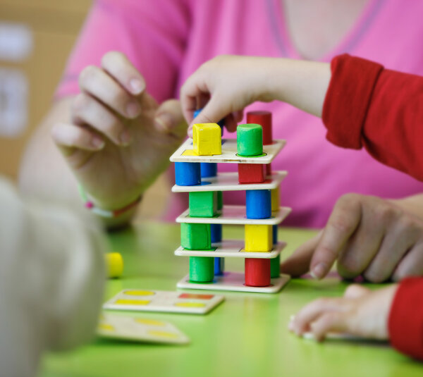 Children playing with homemade educational toys