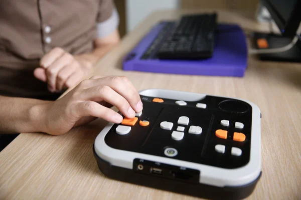 Blind person using audio book player for visually impaired — Stock Photo, Image