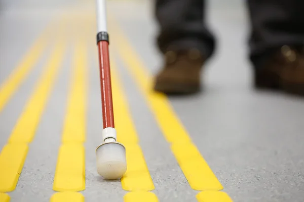 Blind pedestrian walking on tactile paving — Stock Photo, Image