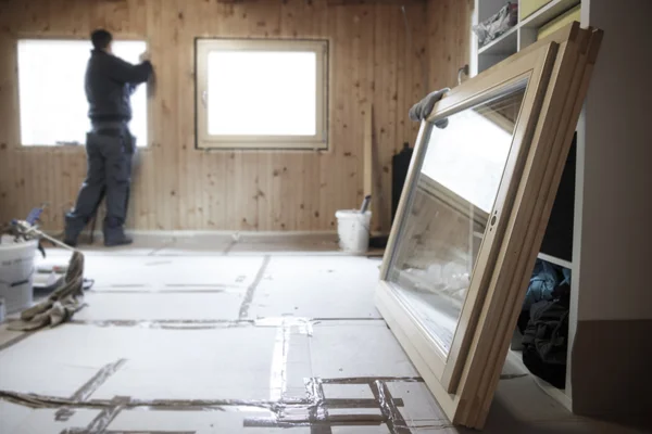 Worker installing new wooden windows — Stock Photo, Image