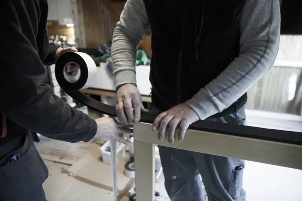 Workers preparing to install new wooden windows