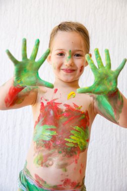 Little girl showing her hands, covered in finger paint  clipart