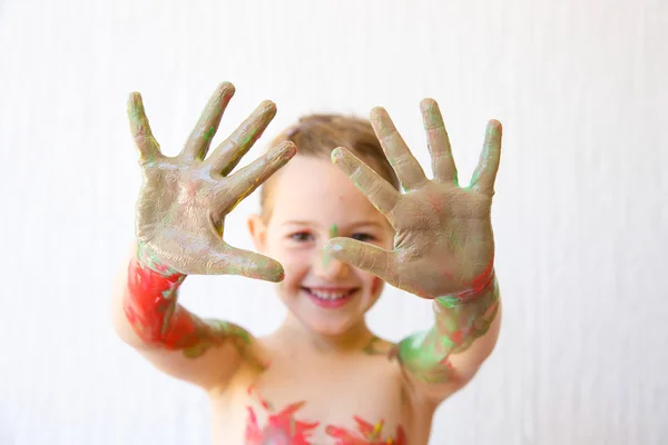 Little girl showing her hands, covered in finger paint — Stock Photo, Image