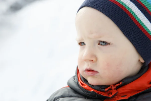 Blue eyed little boy in a winter landscape — Stock Photo, Image