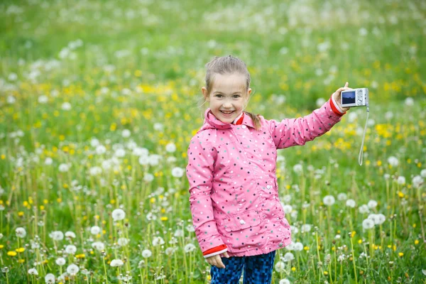 Little smiling girl proudly showing her photograph — Stock Photo, Image