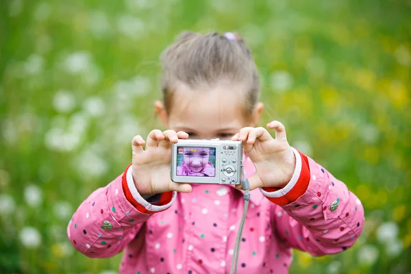 Little girl making a selfie with digital camera — Stock Photo, Image