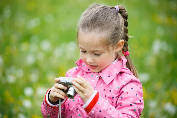 Girl reviewing photos she made with digital camera — Stock Photo, Image