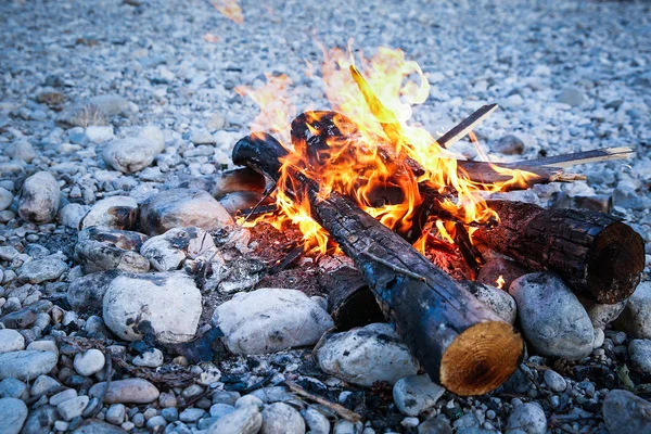 Self-made campfire on shore of mountain river — Stock Photo, Image