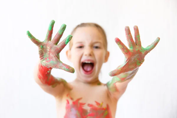 Little girl showing her hands, covered in finger paint — Stock Photo, Image