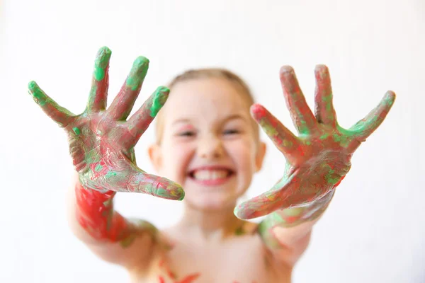 Little girl showing her hands, covered in finger paint — Stock Photo, Image