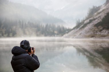 Photographer holding a camera, taking photos