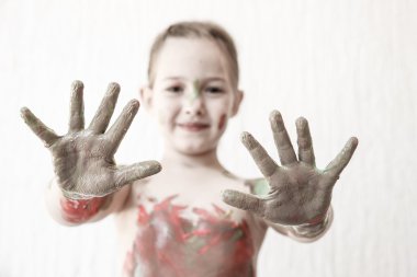 Little girl showing her hands, covered in finger paint  clipart