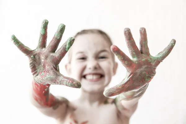 Little girl showing her hands, covered in finger paint — Stock Photo, Image