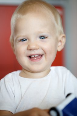 Happy and cheerful little toddler, playing and having fun