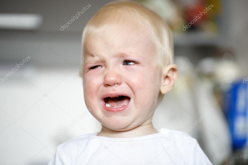 Small and sick crying toddler in pain