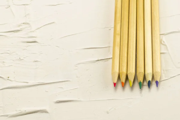 six wooden pencils of different colors of diversity bus