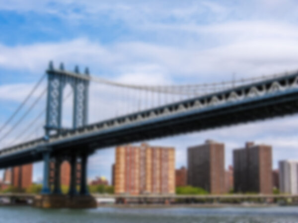 Defocused background with New York skyline and Manhattan Bridge on the Hudson river. Intentionally blurred post production for bokeh effect