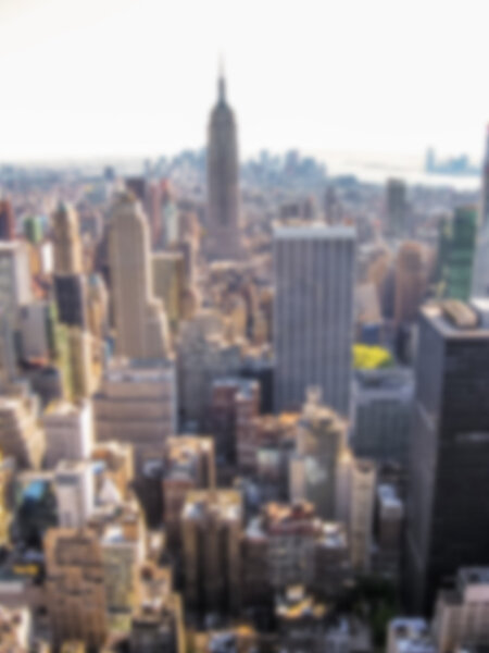 Defocused background with cityscape of NYC from the Top of the Rock at Rockefeller center with Empire State Building, Manhattan, United States. Intentionally blurred post production for bokeh effect.