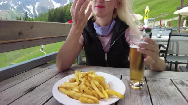 Mulher bebendo cerveja com batatas fritas — Vídeo de Stock