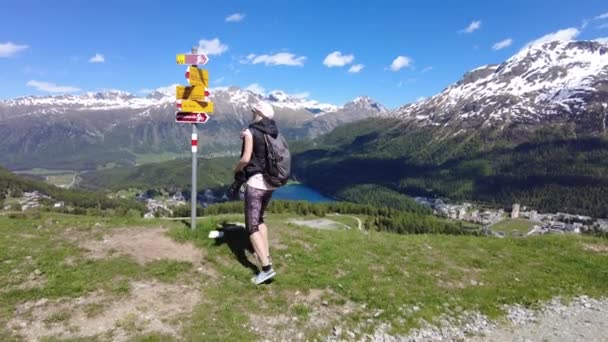 Woman backpacker trekking in Switzerland — Video
