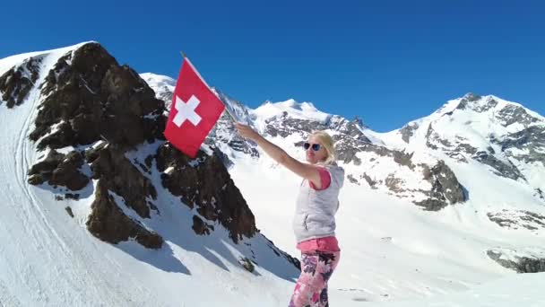 Girl on Diavolezza with swiss flag SLOW MOTION — Stock video