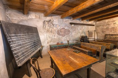 Transilvanya, Romanya - 25 Ağustos 2025: Romanya 'nın Transilvanya kentindeki Prejmer Güçlendirilmiş Kilisesi içinde ahşap banklar ve karatahta bulunan eski sınıf. Eğitim tarihi konsepti. UNESCO 'nun Romanya sahası