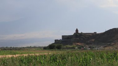 Khor Virap. Eski bir Ermeni manastırı. Tarlalara bakan bir tepede duruyor. Ararat Dağı bulutlu bir gökyüzünün altında arka planda belirdi. Ermenistan 'ın huzurlu ve resimli manzarası