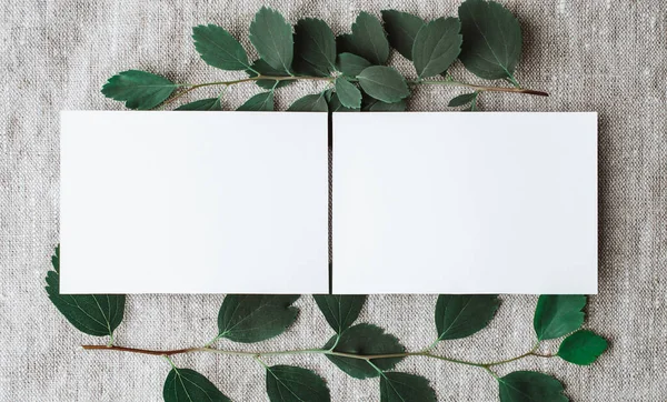 Blank personal card, stationery mockups with natural sunlight and botanical shadows on Gray linen tablecloth fabric background. With copy space.