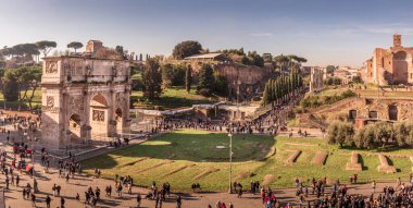 The south side of the Arch of Constantine and Temple of Venus and Rome in Rome, Italy. Panoramic taken from the Coliseum on a sunny early afternoon clipart