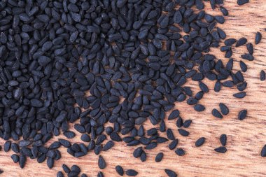 Ahşap zemin üzerinde siyah kimyon tohumları, yakın çekim