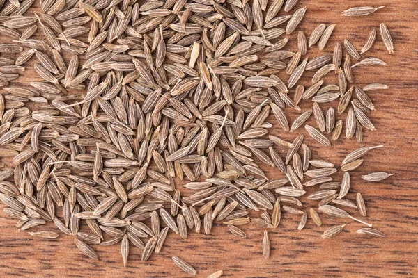 Getrocknete Kümmel-Samen auf Holzgrund, Nahaufnahme, Bio-Lebensmittel — Stockfoto