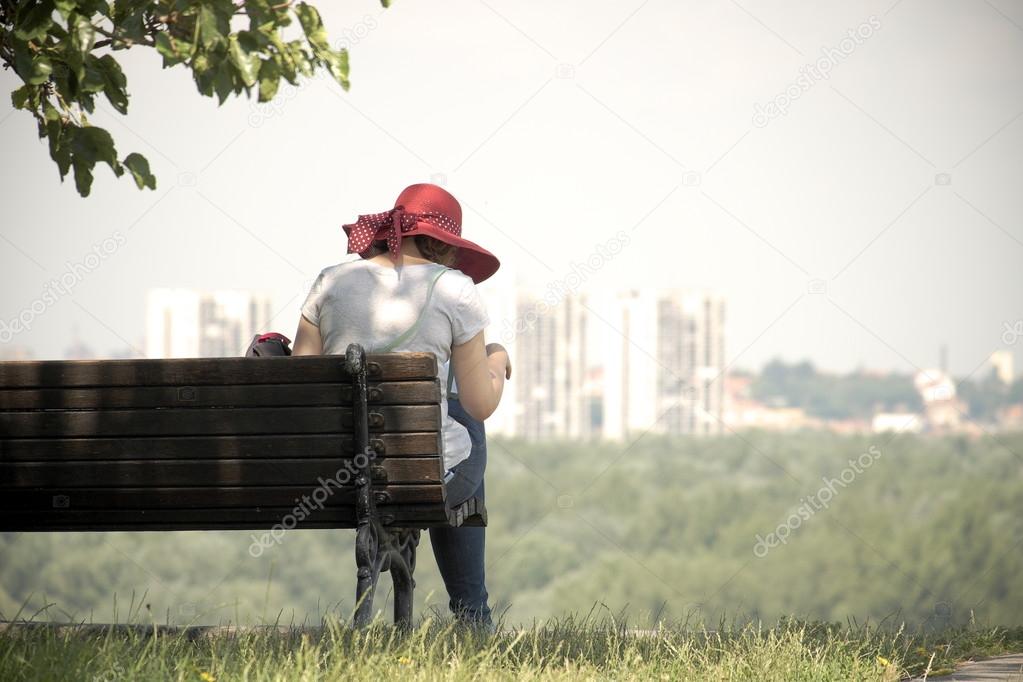 Woman With Red Hat Sitting On A Bench, Belgrade 