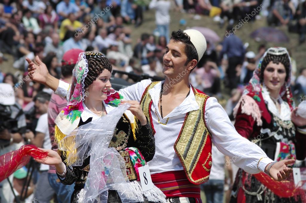 Young couple in albanian costume performs a courtship dance in Lepushe
