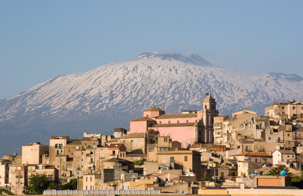 view of village and belltower on background Etna