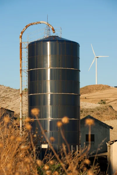 Silos metal on background wind turbine — Stock Photo, Image