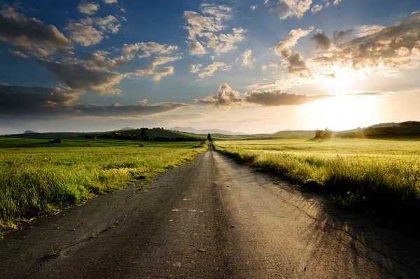 Long straight road middle of rural area — Stock Photo, Image