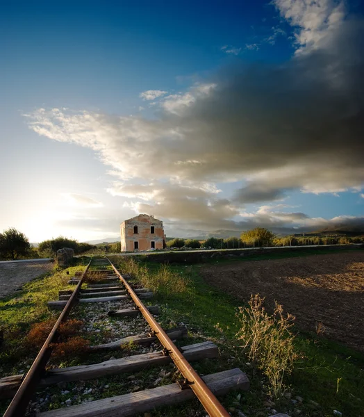 Old railway and station abandoned to sunset — Stock Photo, Image