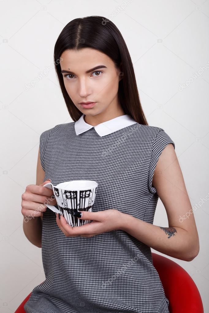 Beautiful  girl  in  dress  with cup