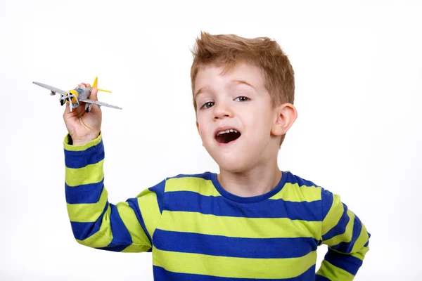little boy with an airplane toy
