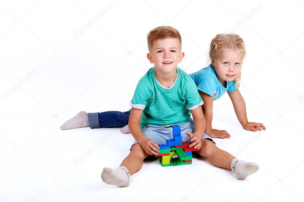 boy and girl playing with plastic blocks