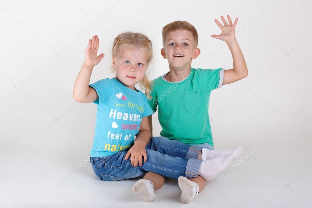 boy and girl raised hands up