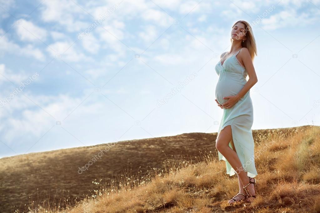 Pregnant woman in white dress