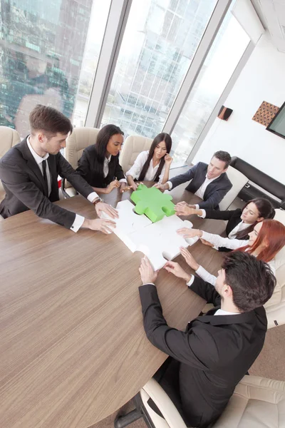 Business people assembling puzzle — Stock Photo, Image